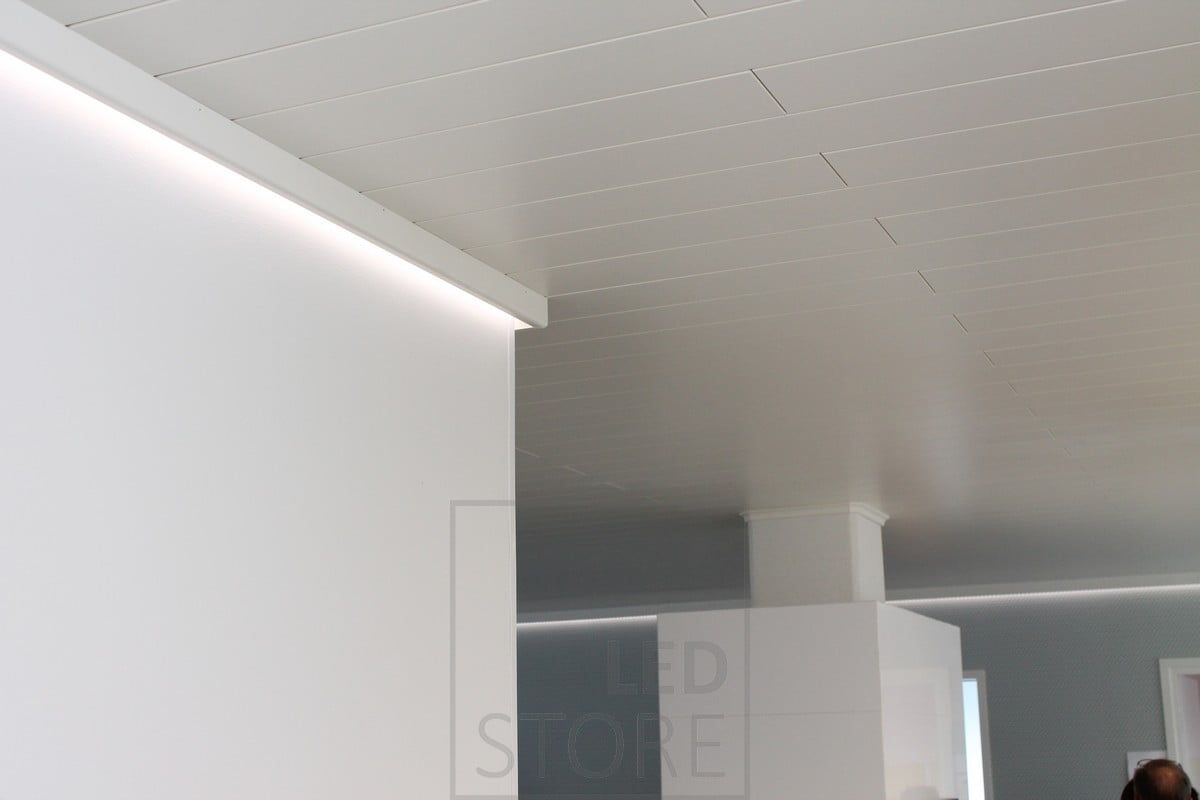 Behind the decorative strip, a wall-lit LED strip creates soft mood lighting.
